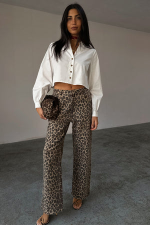 White Cropped Cotton Miley Shirt with tortoise buttons and blouson sleeves, styled with leopard print trousers.