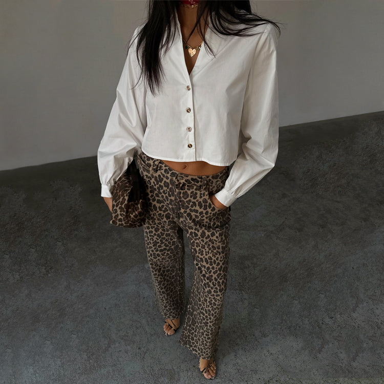 White Cropped Cotton Miley Shirt with tortoise buttons and blouson sleeves, styled with leopard print trousers.