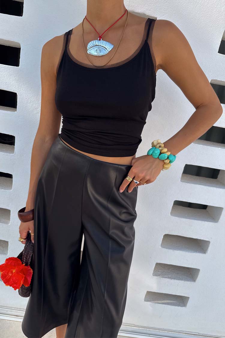 Black Vegan Leather Culottes featuring a wide leg and front crease, styled with turquoise accessories.