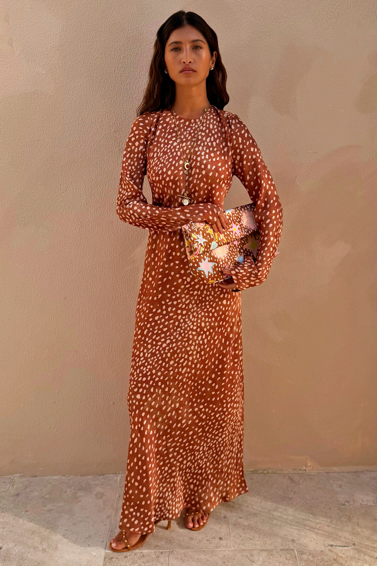 Fawn Soho Maxi Dress in brown satin-esque fabric with a cream deer print and flared sleeves on a model.