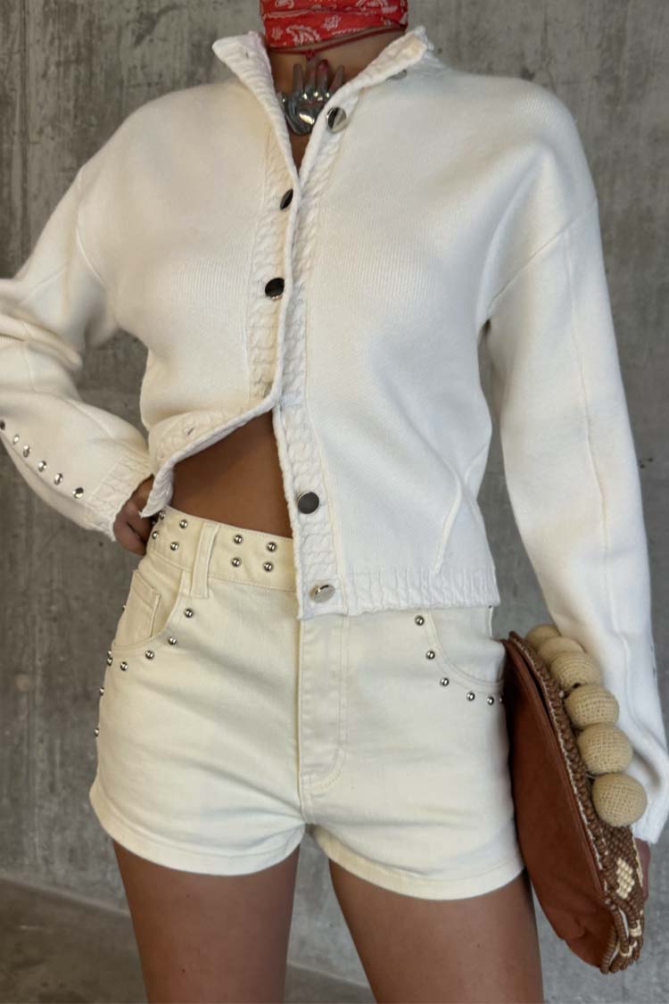 Ecru Studded Hot Pant featuring silver stud detailing on cream denim, styled for a festival look.