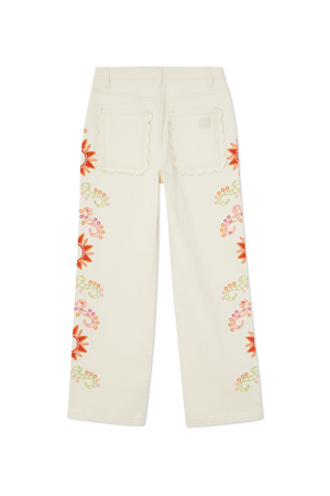 Jeans ecru a gamba larga con tasche posteriori a smerlo e ricami a sole colorati lungo le cuciture laterali.