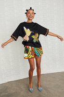 Thumbnail for caption_Model wears Black Fiji T-Shirt in UK size 10/ US 6