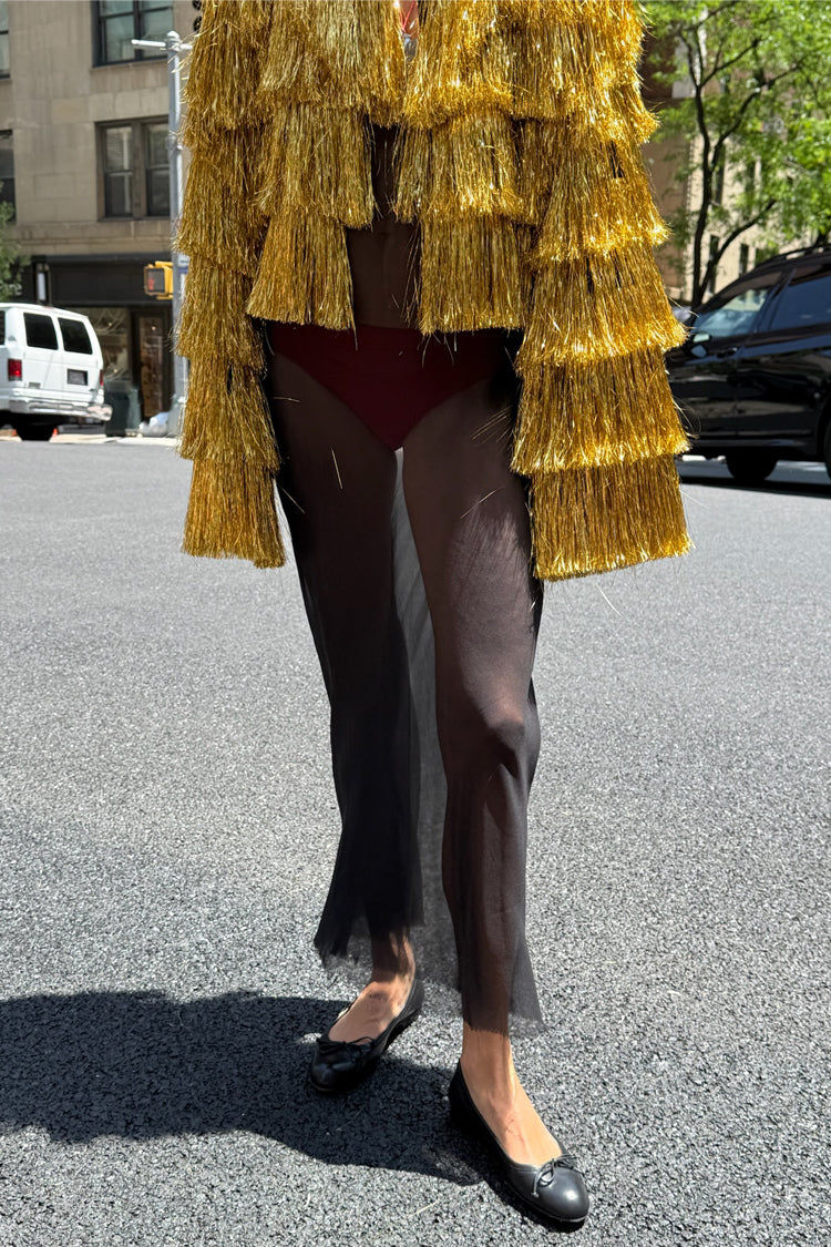 Gold Fringe Jacket with tiered foil tassels, a statement staple styled with a sheer black skirt on a city street.