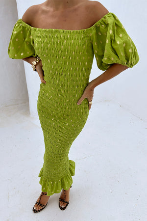 Olive Jojo Dress with Gold Fleck, shirred body and puff sleeves, worn off-the-shoulder by a 5ft5 model in UK size XS.