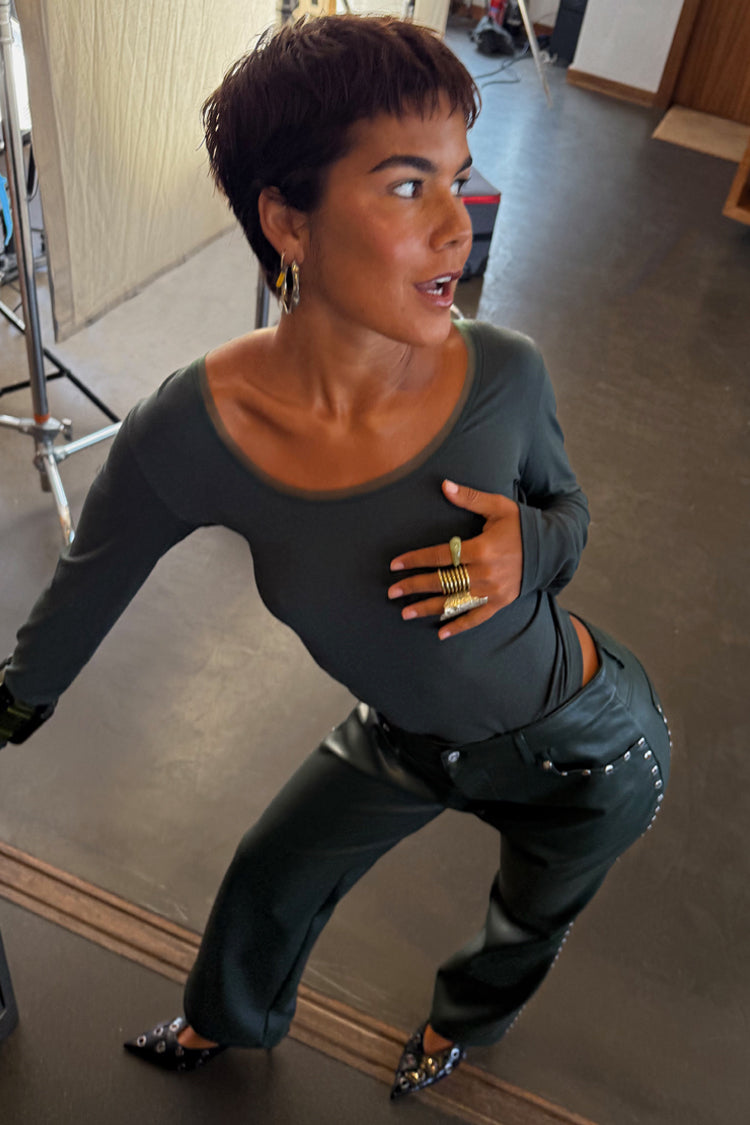 Dark green long sleeve Teddy T-shirt with mesh neckline detail and studded leather trousers.