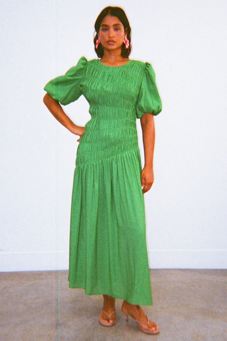 Green Nara Dress with a shirred front, puff sleeves and pleated skirt, an iconic multi-wear midaxi style.