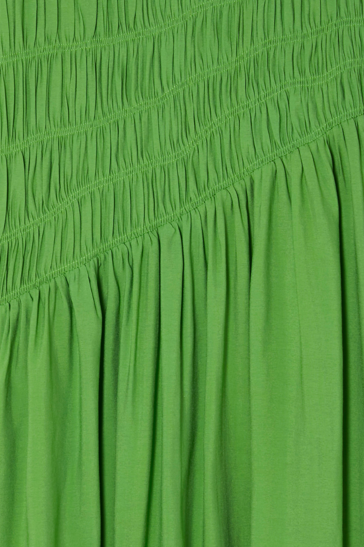 Green Shirred Nara Dress close-up highlighting the elastic shirring and lightweight pleated green fabric.