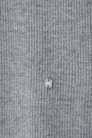 Gunmetal Rib Knit Jumper detail with grey shimmering rib fabric and a small silver metal NFD logo.