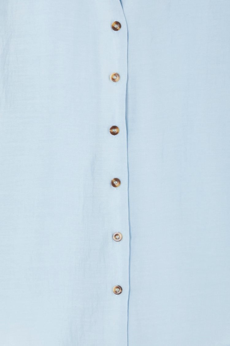Ice Blue Miley Shirt detail with contrast tortoise buttons on sky blue, lightweight and slightly sheer fabric.