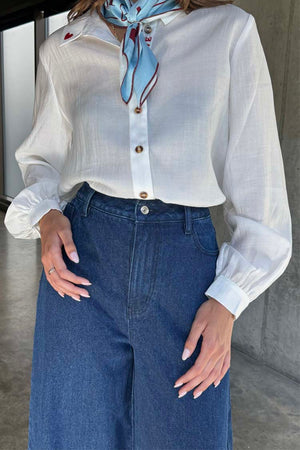 Blue Denim Pallazzo Jan Jean in a wide-leg style, styled with a white shirt and a patterned neck scarf.