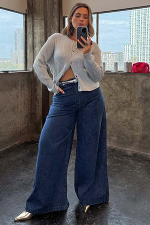 Blue Denim Pallazzo Jan Jean with a voluminous wide-leg fit, styled with a silver cardigan for an effortless London look.