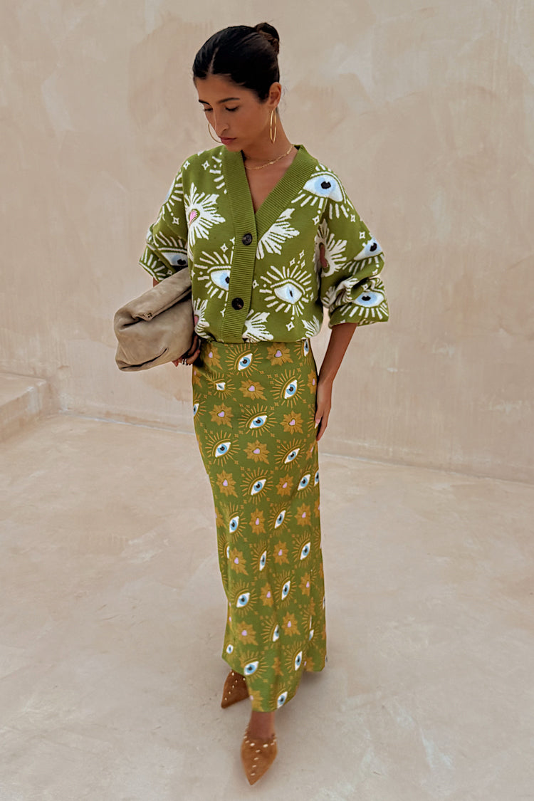 Khaki Eye Dorris Skirt with a green heart and eye print, styled with a matching cardigan for a coordinated London look.