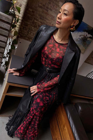 Black Leather Blazer in a relaxed fit with shoulder pads, styled over a cherry print dress with fringe.