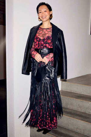 Black Leather Blazer draped over a cherry-print dress and fringed bag for a multi-wear transeasonal look.