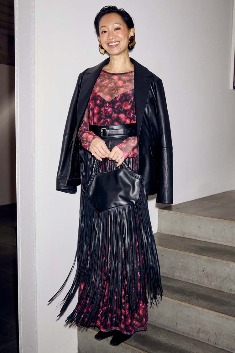 Black Leather Blazer draped over a cherry-print dress and fringed bag for a multi-wear transeasonal look.
