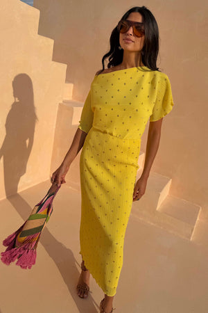 Yellow Sunshine Tilly Dress in plisse with gold flecks, worn by a 5ft7” model in size UK 10/US 6.