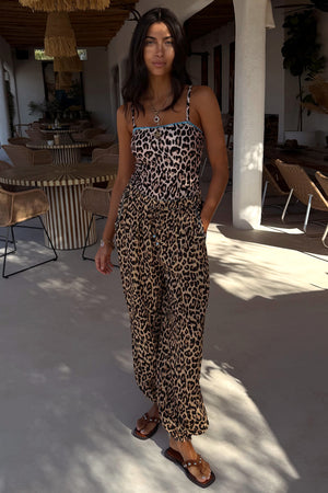 Leopard print swimsuit with blue whipstitch detail and matching balloon trousers for a vacation look.