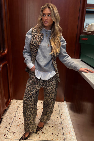 Iconic cotton Leopard Waistcoat layered over a grey jumper and matching barrel jeans for a statement London look.