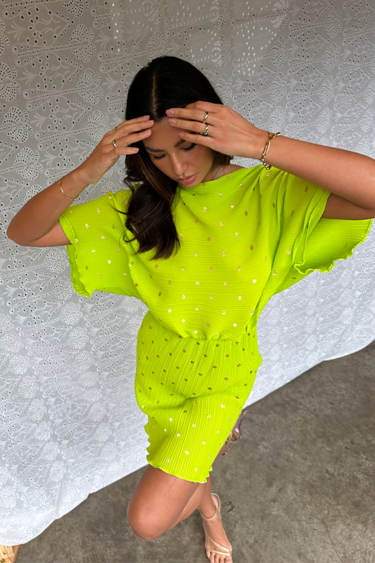 caption_Model wears Lime Plisse Mini Tilly Dress in UK size 10/ US 6