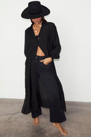 Thumbnail for caption_Model wears Black Longlined Running Wilder Miley Shirt in UK size 10/ US 6