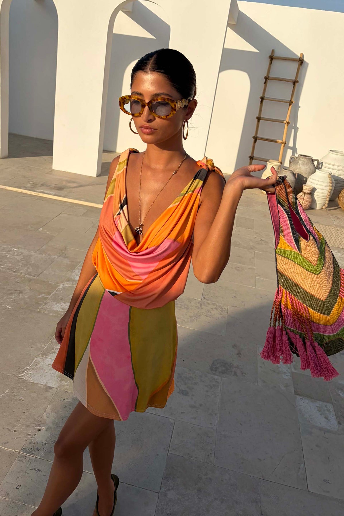 Green Abstract Leila Mini Dress with a cowl neck and adjustable multi-wear straps in a colourful print.