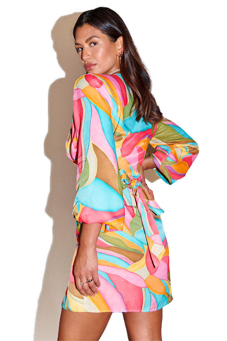 caption_Model wears Multi Abstract Vienna Mini Wrap Dress in UK size 10/ US 6