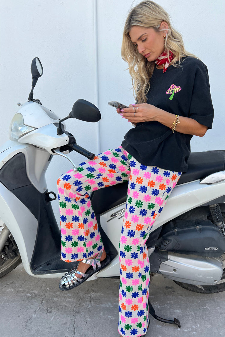 Model wearing multi flower trousers with black washed mushroom t-shirt