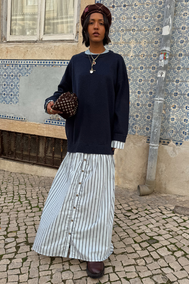 Navy knit jumper dress featuring a blue striped cotton skirt with button-down detail and midaxi length.