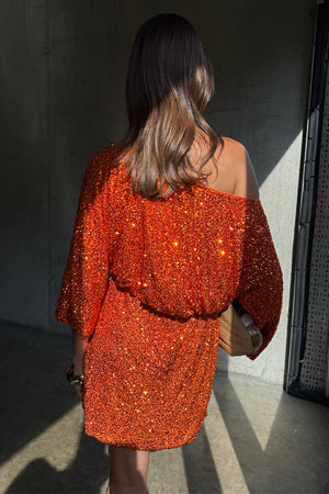 Orange Sequin Tilly Dress in shimmering burnt orange with an off-the-shoulder silhouette and mini length.