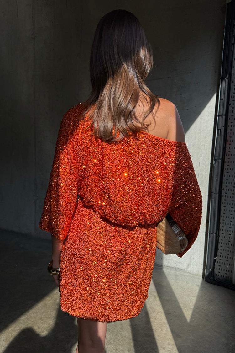 Orange Sequin Tilly Dress in shimmering burnt orange with an asymmetric off-the-shoulder silhouette.