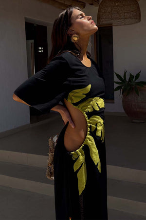 Black Palm Riviera Dress with lime palm motifs and adjustable cut-out waist detail, ideal for a summer vacation.