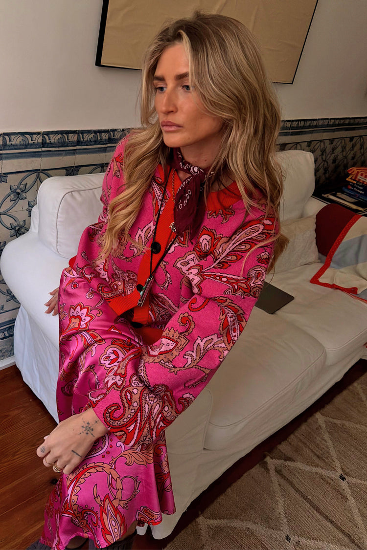 Pink Paisley Oslo Cardigan in a soft knit with red ribbed trims, styled with a matching skirt for a bold London look.