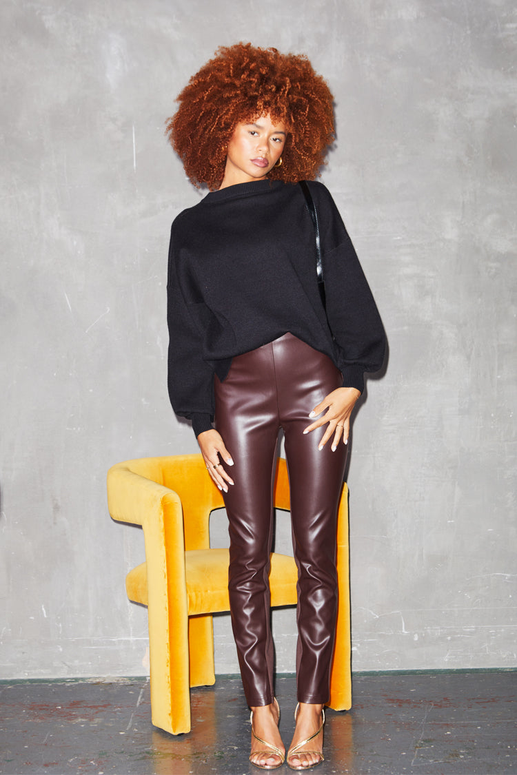 Model Wearing chocolate vegan leather Ponte Leggings sitting full length standing up