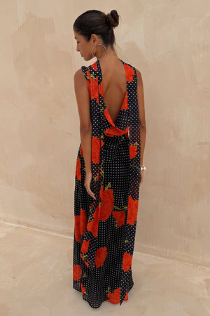 Black Poppy Sophie Dress with red poppies and white polka dots, featuring a statement draped back and scarf detail.