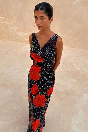 Black Poppy Sophie Dress with red floral and polka dot print, featuring a draped scarf neckline and sleeveless design.