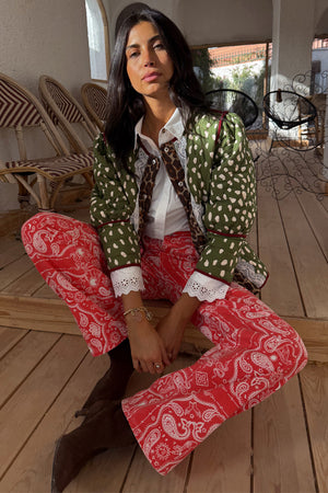 Red Bandana Jeans Petite in a paisley print, paired with a green quilted jacket and white eyelet shirt.