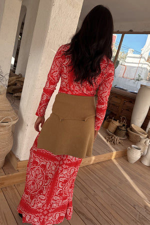 Red Bandana Rib Dorris Skirt co-ord in an iconic print, styled with a tan wrap layer and shown from the back.