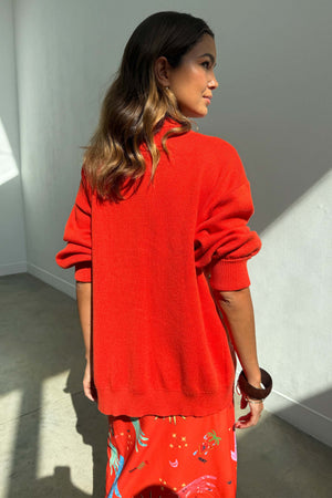 Red Celestial Cardigan in a soft knit with ribbed cuffs, styled with a matching printed skirt.