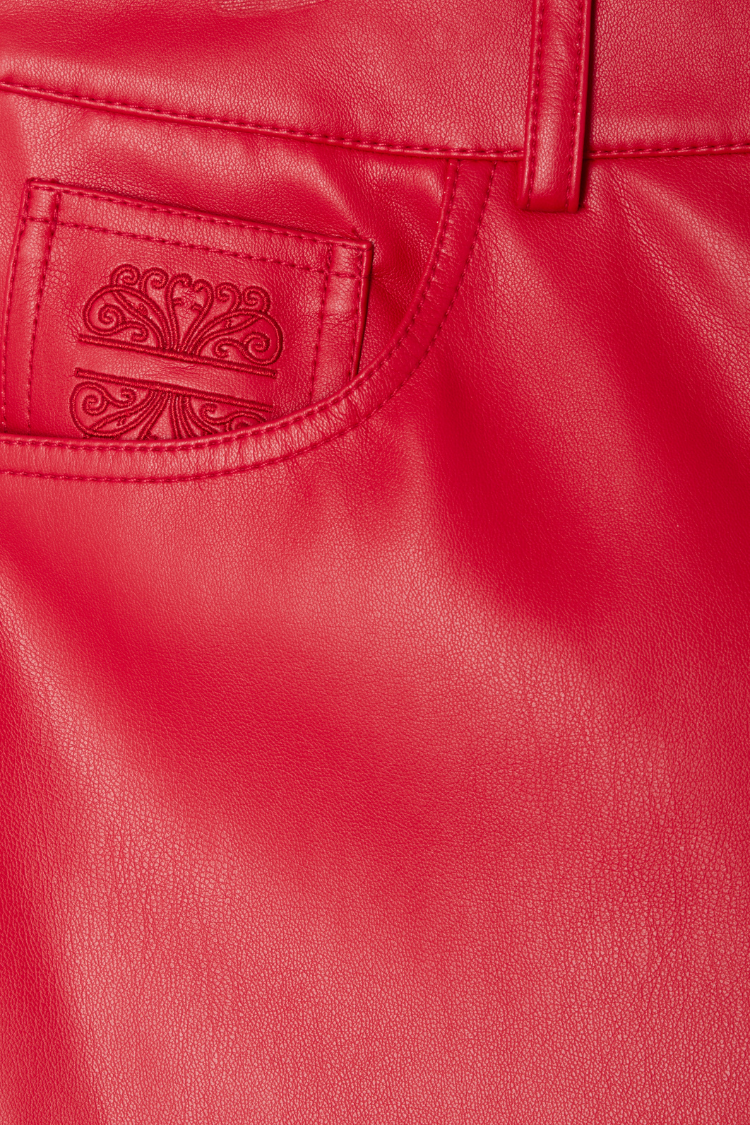 Deep red vegan leather trousers featuring an embroidered pocket logo detail.