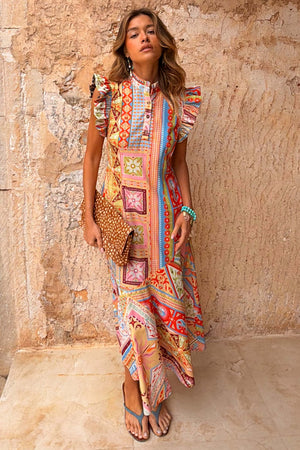 Dolce Vita Remi Dress in a sunset-toned patchwork print with a high neck and statement ruffle sleeves.