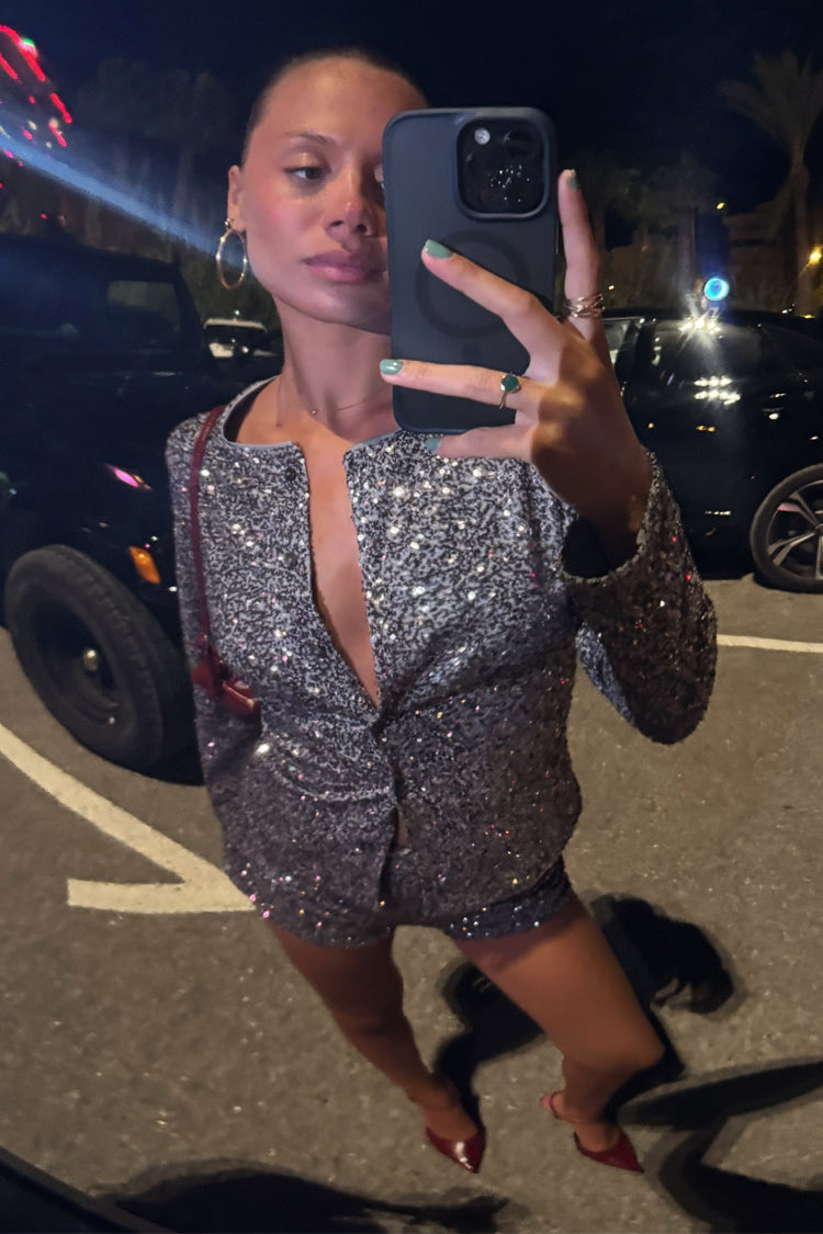Gunmetal Alexa Sequin Cardigan and co-ord hot pants worn by a model taking a mirror selfie.