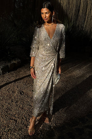 Silver Sequin Kira Wrap Dress featuring a multi-wear wrap fastening and long sleeves, styled as a maxi party dress.