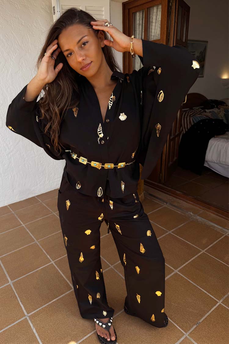 Black Shell Elissa Trousers in a cotton-linen blend with gold shell prints and a wide-leg fit, styled as a co-ord.