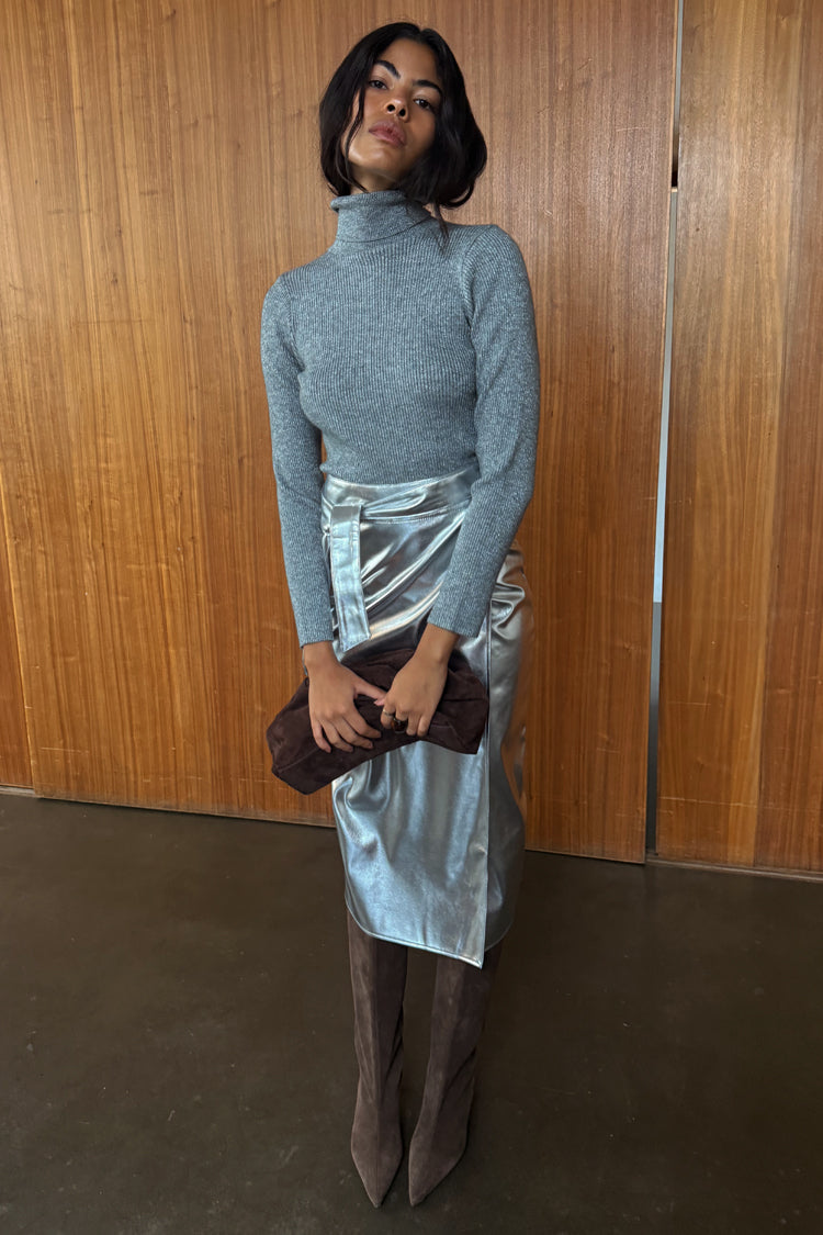 Iconic Silver Vegan Leather Jaspre Skirt styled with a grey roll neck and brown suede boots.