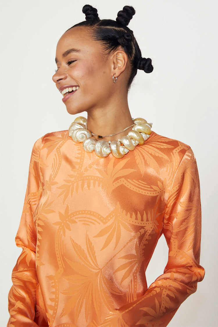 caption_Model wears Apricot Palm Mini Soho Dress in UK size 10/ US 6