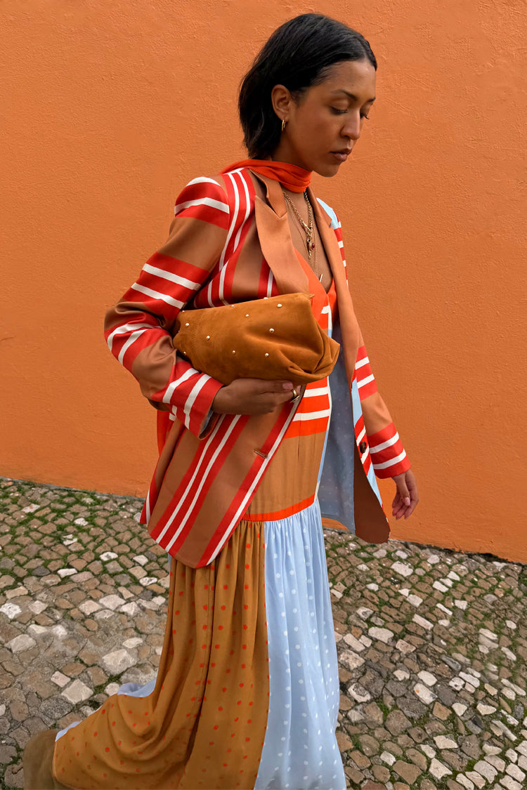 Longline Multi Stripe Blazer in red and blue styled with a tan suede clutch and a patterned maxi dress.