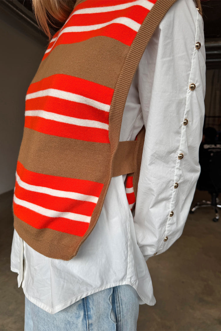 Multi Stripe Tank Top in tan and red knit, layered over a white shirt with gold button sleeve details.