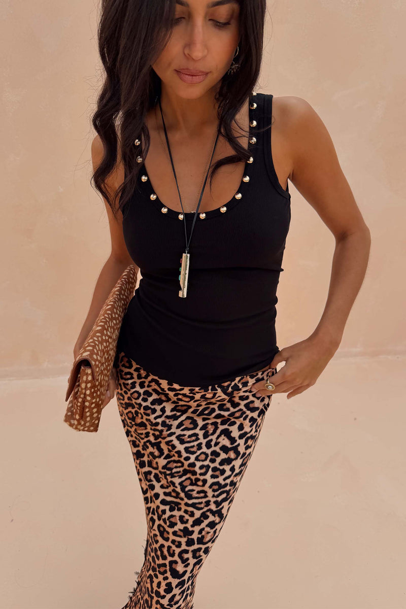 Black Studded Rib Vest with gold stud detailing, paired with a leopard print skirt for a London look.