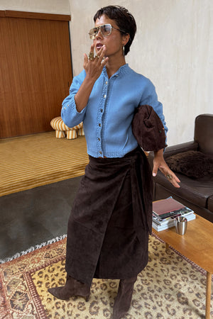 NFD Chocolate Suede Jaspre wrap midi skirt styled with a blue cardigan and brown suede boots.